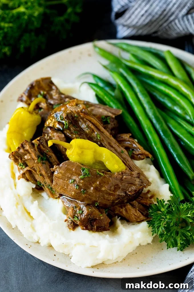 Mississippi Pot Roast with Mashed Potatoes and Green Beans Shredded Mississippi pot roast served over creamy mashed potatoes, accompanied by green beans with bacon.