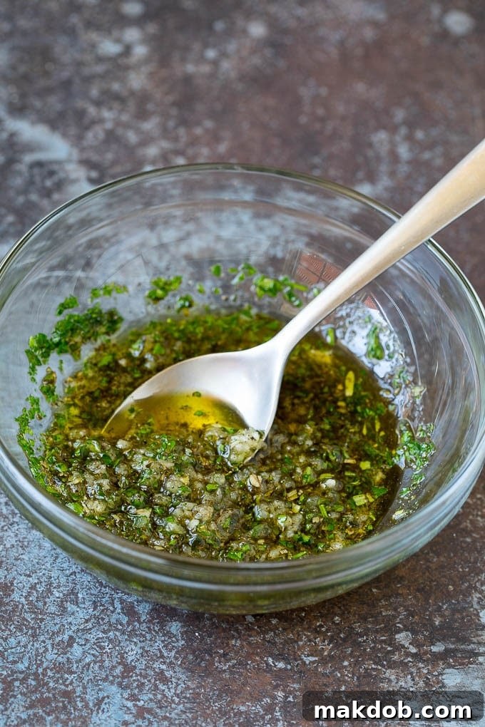 This rack of lamb is coated with garlic and fresh herbs, then roasted in the oven until tender and juicy. A bowl of garlic and herb olive oil.