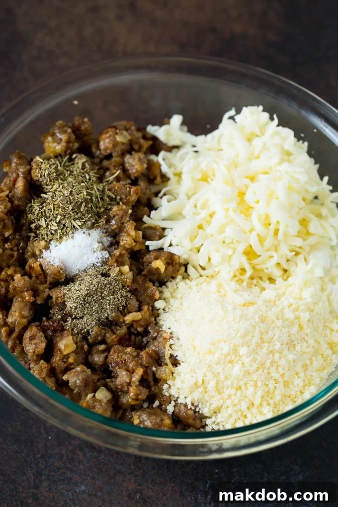Mixing bowl with ricotta cheese, mozzarella, Parmesan, and herbs for manicotti filling.
