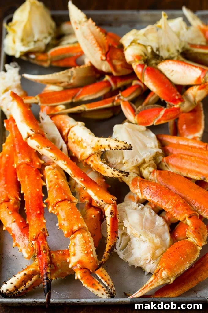 An assortment of different types of crab on a sheet pan.