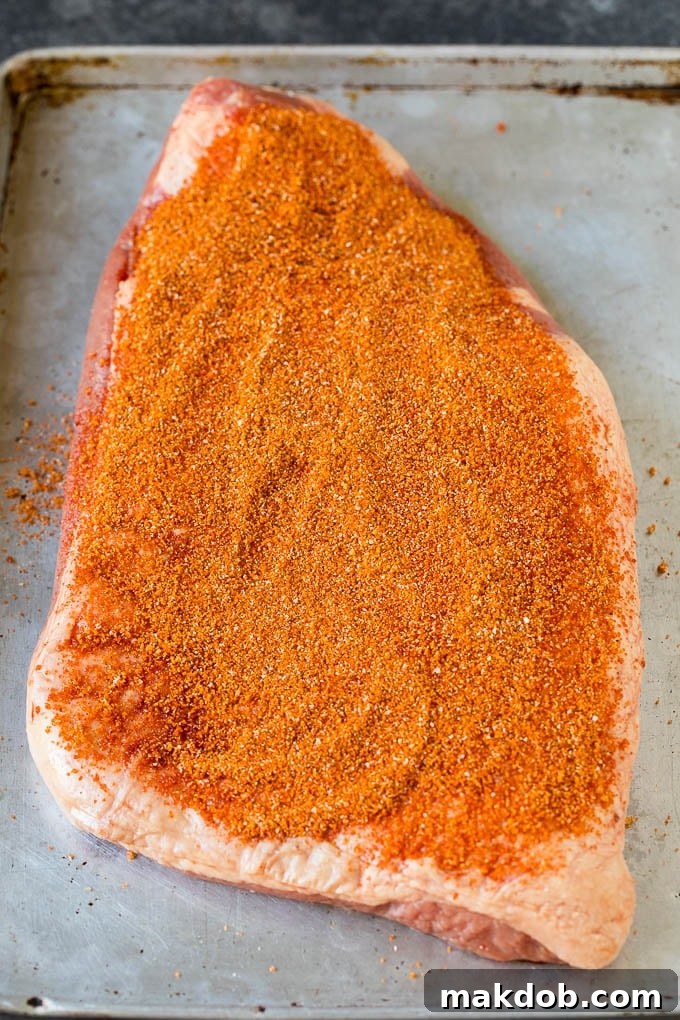 Brisket rub spread over a beef brisket.