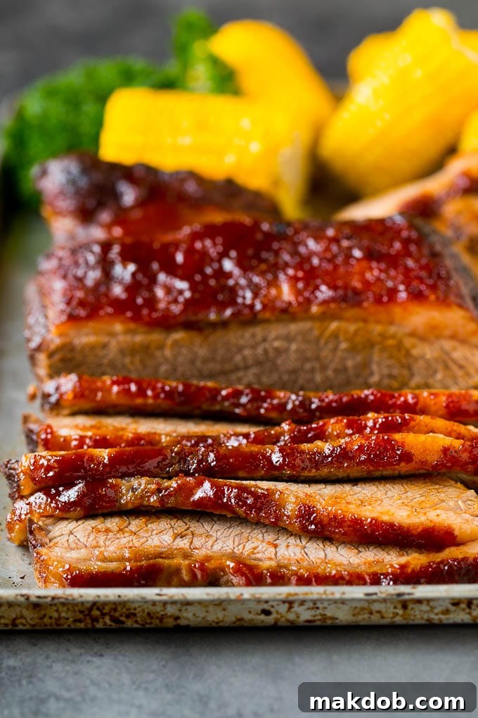 Sliced beef brisket on a sheet pan.