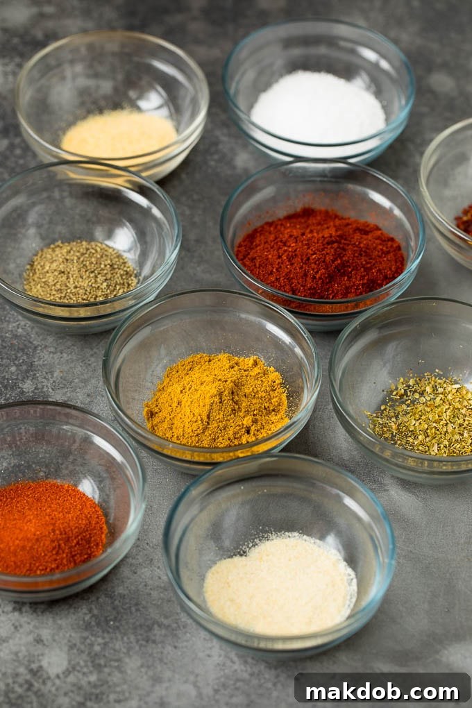 Homemade taco seasoning with a savory mix of spices, this blend can be used in all different types of Mexican food. Assorted spices in small bowls, ready to be combined for taco seasoning.