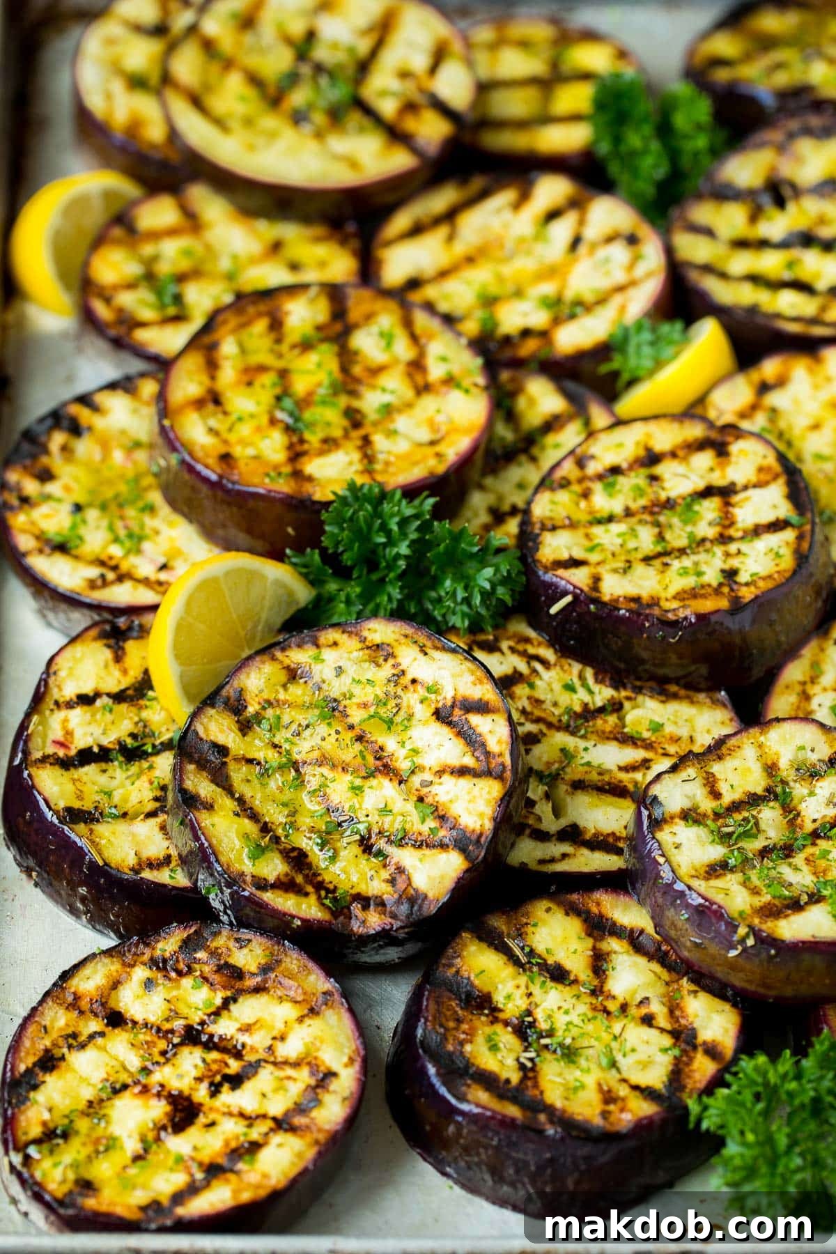 Fire-Kissed Eggplant 6 A pan of grilled eggplant slices topped with fresh parsley, ready to be served.