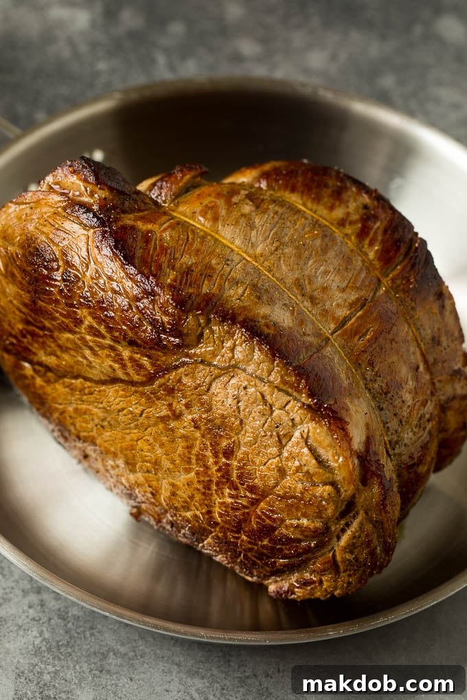 A browned chuck roast in a pan.