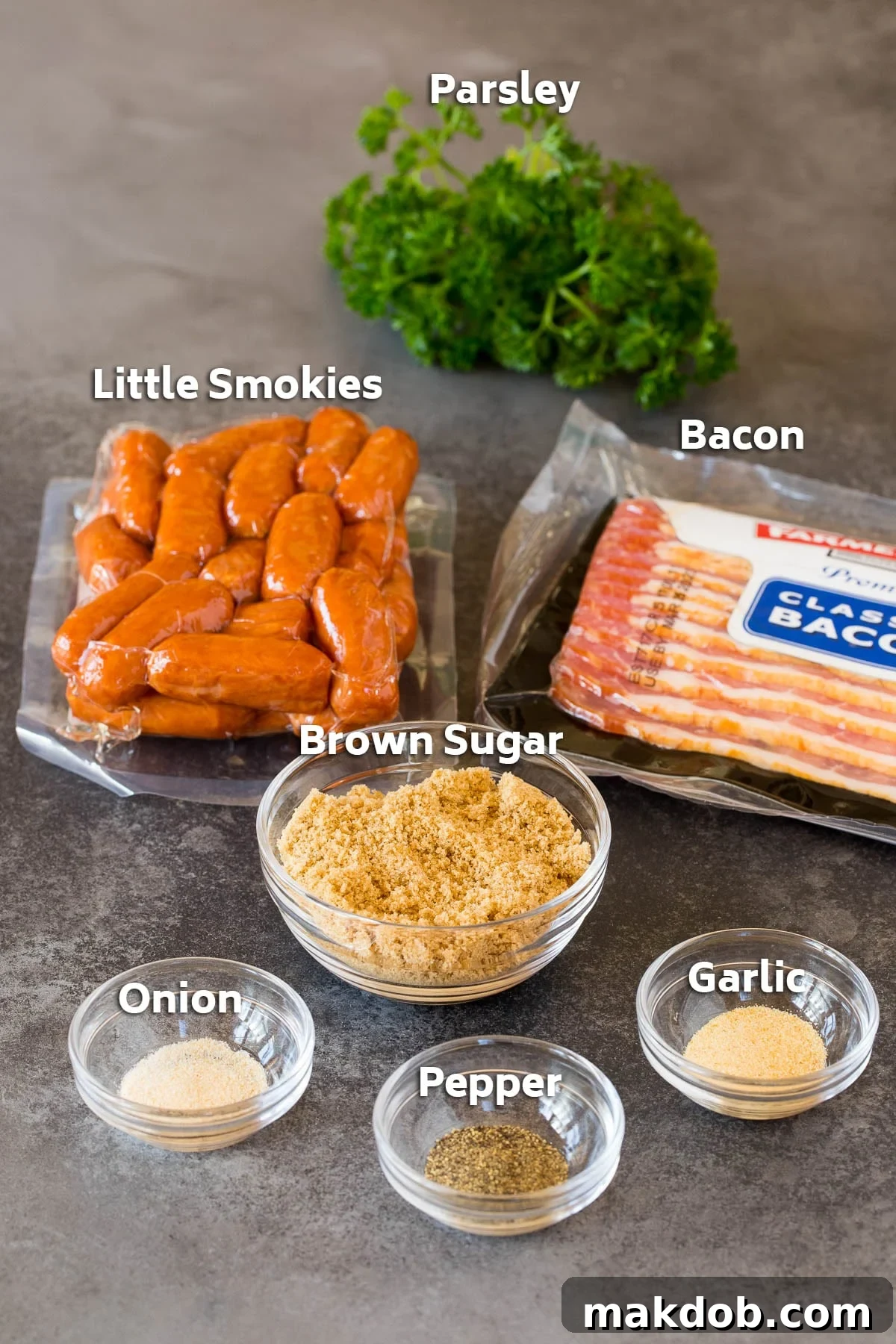 A collection of raw ingredients for bacon wrapped smokies, including packages of cocktail sausages and bacon, a bowl of brown sugar, and small containers of spices.