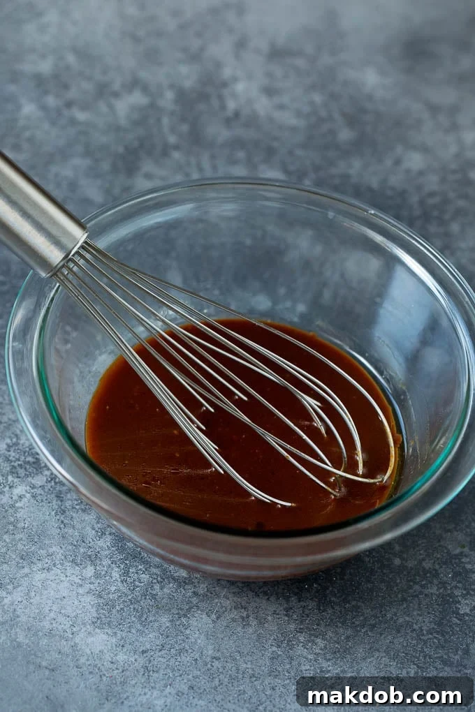 A bowl of homemade sesame ginger dressing, showcasing its rich texture and color.
