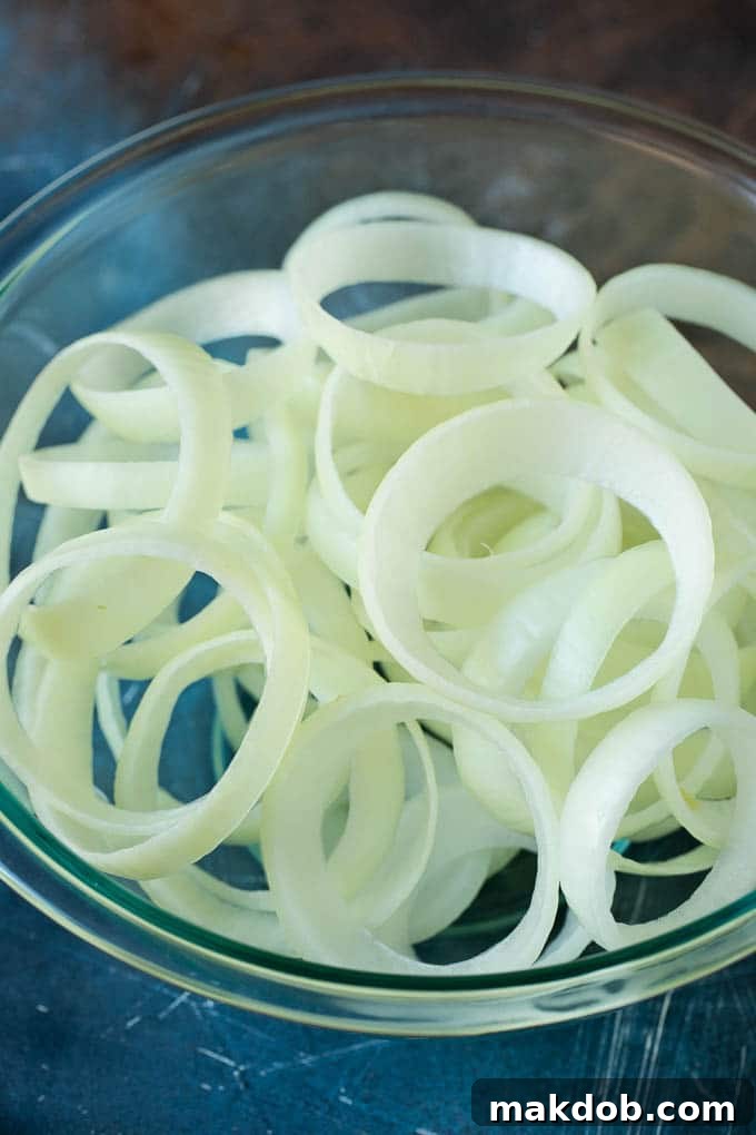 Raw onion slices in a bowl.