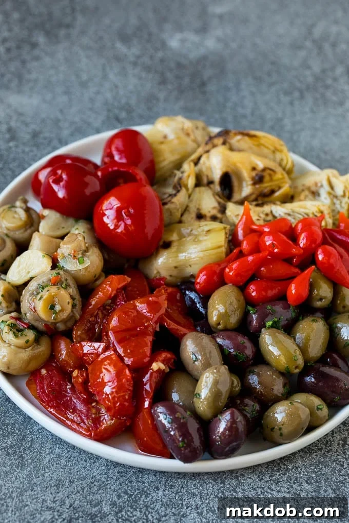 An Odyssey of Mediterranean Flavors 4 A plate of olives, peppers and grilled artichokes.