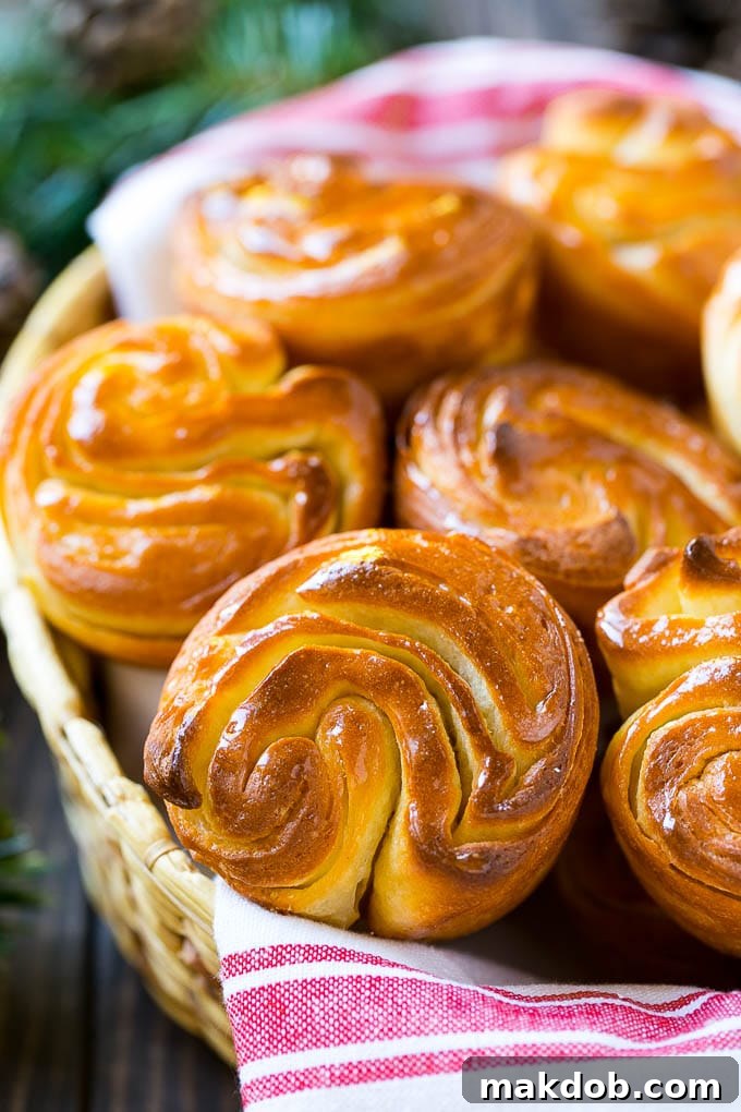 A close up of butterflake rolls in a woven basket.