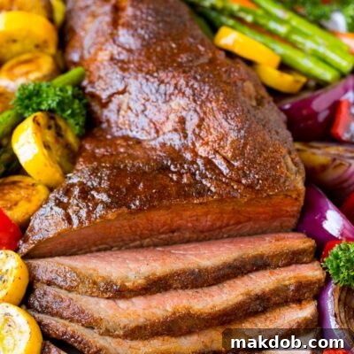A platter of smoked tri tip served with vegetables.