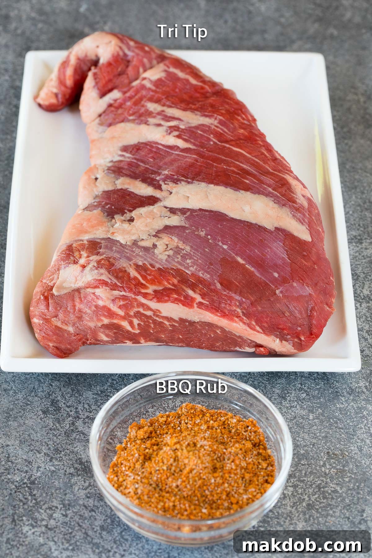 Smoky Tri Tip Perfection 3 A beef roast and a bowl of BBQ rub, the simple ingredients for smoked tri tip.