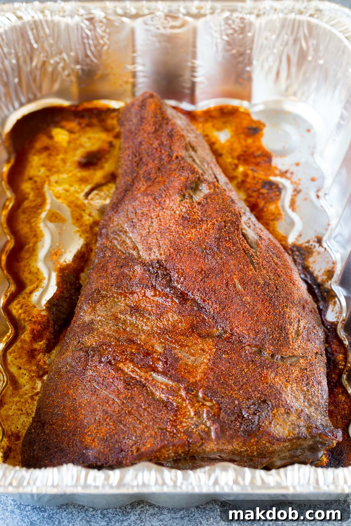 Smoky Tri Tip Perfection 5 Tri tip roast developing a browned crust after being broiled in a roasting pan.