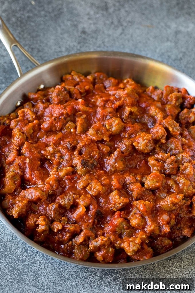 Simmering Meat Sauce for Baked Pasta Meat pasta sauce simmering in a skillet, rich and ready for combining with pasta.