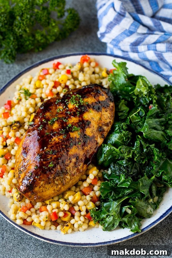 Grilled chicken breast served alongside a generous portion of freshly sauteed kale.
