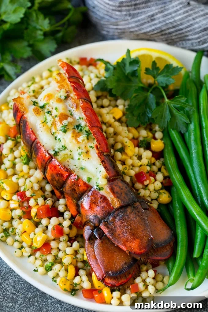 Grilled lobster tail beautifully plated with fluffy couscous and crisp green beans for a complete meal.