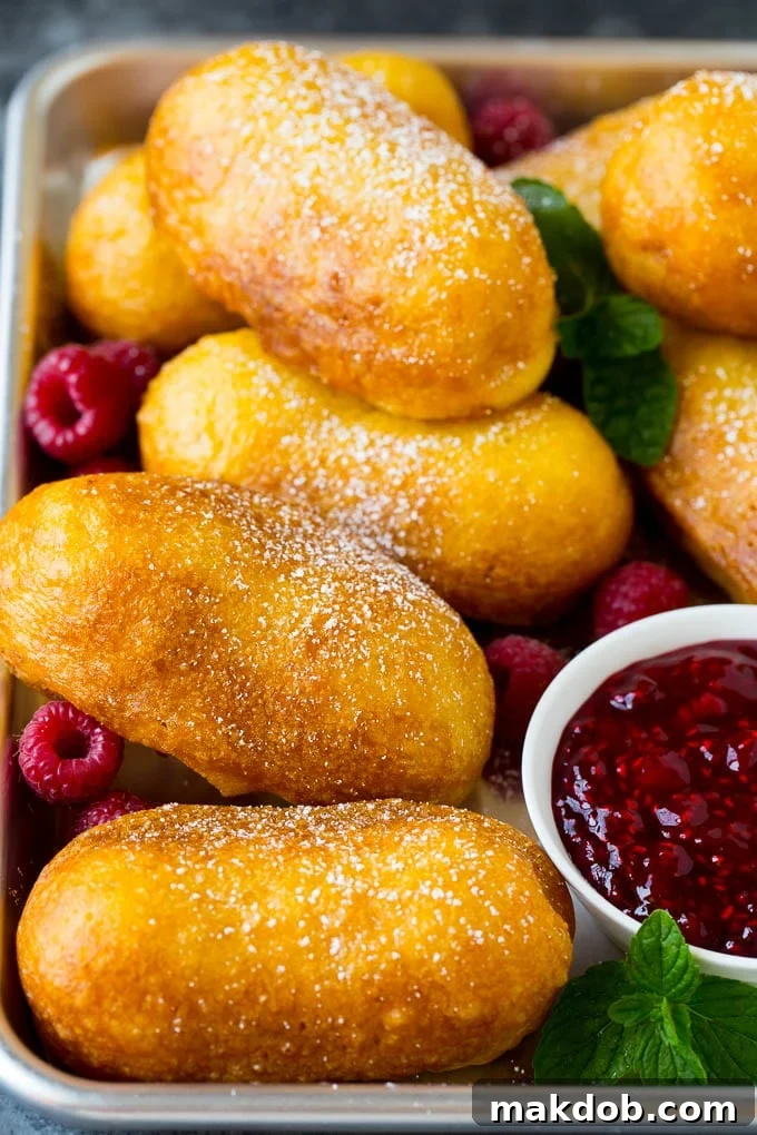 Fried Twinkies are a remake of the carnival classic that are fun and easy to make at home. A tray of fried Twinkies topped with powdered sugar.