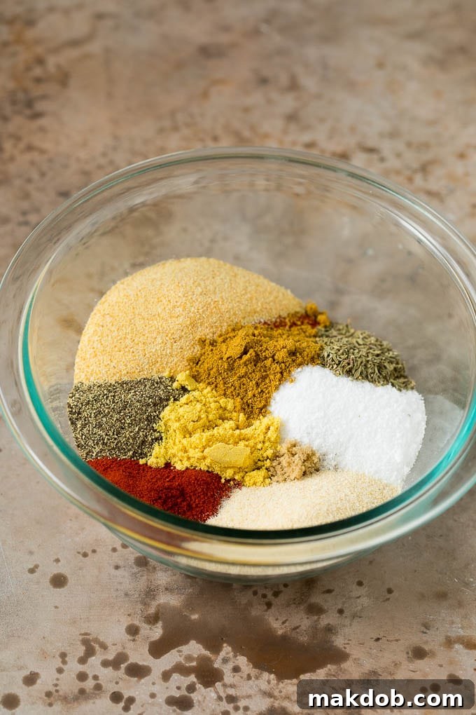 A bowl brimming with a vibrant mixture of herbs and spices for steak seasoning.