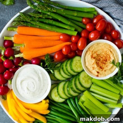 The Ultimate Veggie Tray 2 A large veggie tray with assorted fresh and steamed vegetables, ranch dip and hummus.