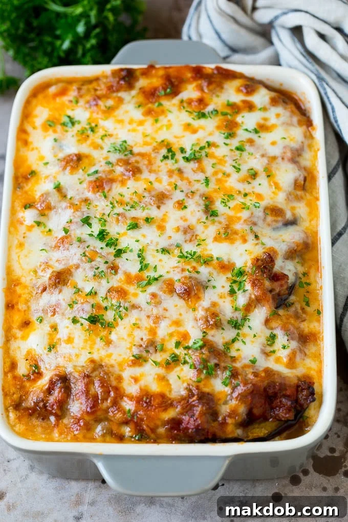 Baked eggplant lasagna topped with fresh chopped parsley, ready to be served.