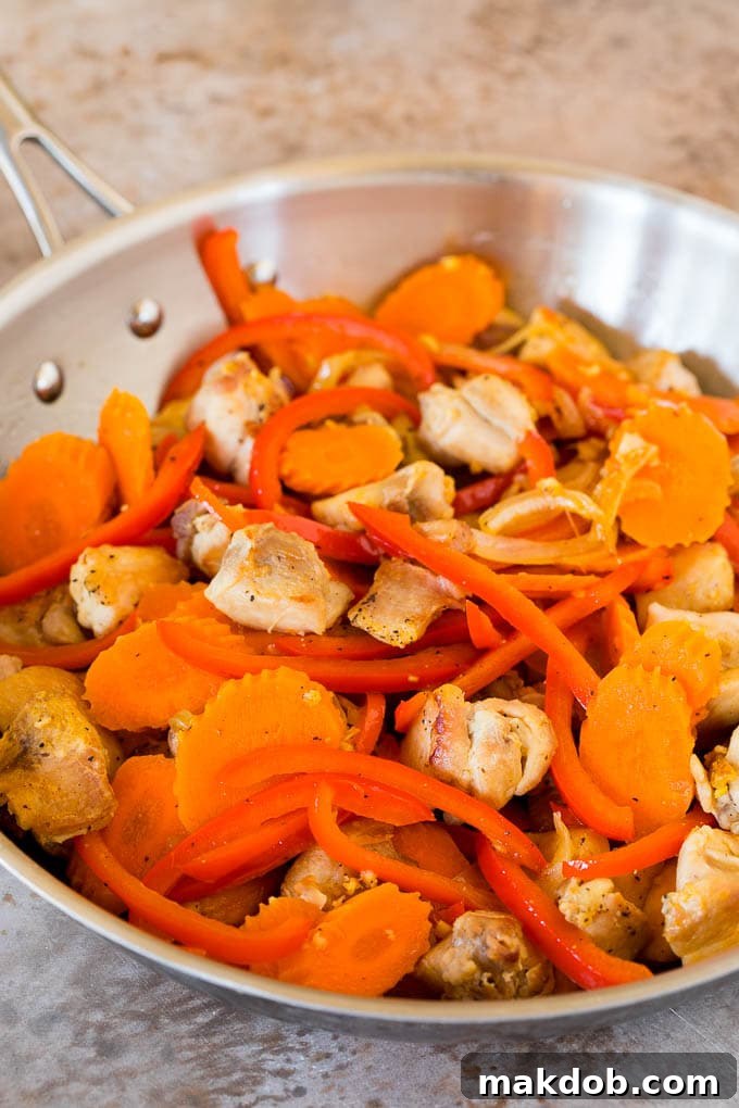 This Thai chicken curry is pieces of tender chicken and colorful vegetables, all simmered together in a coconut red curry sauce. Sauteed chicken, carrots and bell peppers.