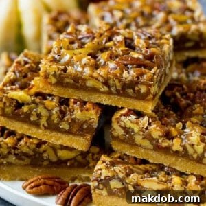 A festive serving platter overflowing with perfectly portioned pecan pie bars, ready for sharing.