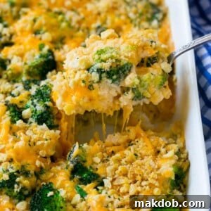 A generous spoonful of creamy, cheesy broccoli casserole, ready to be enjoyed.