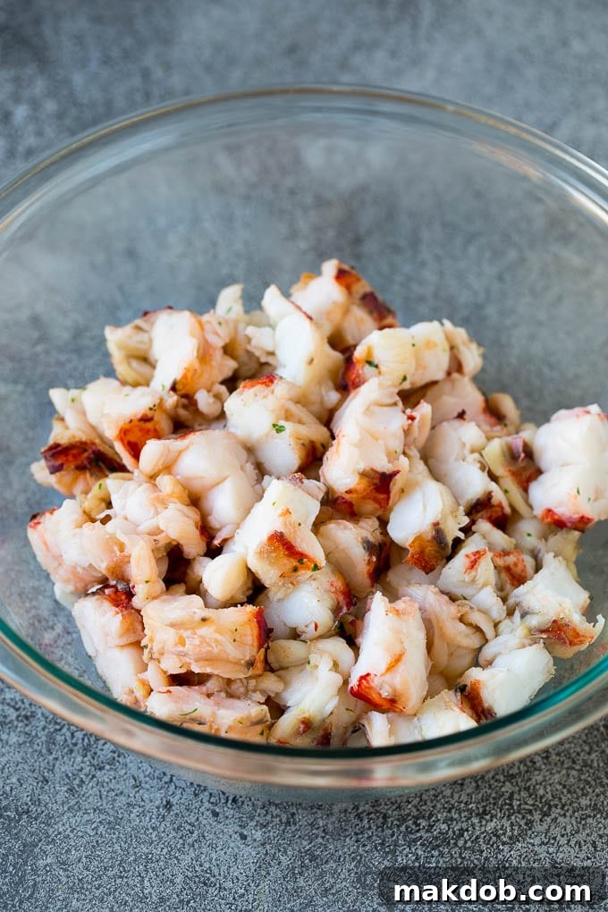Diced fresh lobster meat in a bowl, ready for salad assembly.
