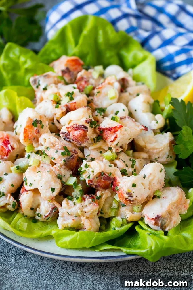 Lobster Salad Served on Lettuce A portion of fresh lobster salad attractively served on a bed of vibrant green lettuce, ready to be savored.