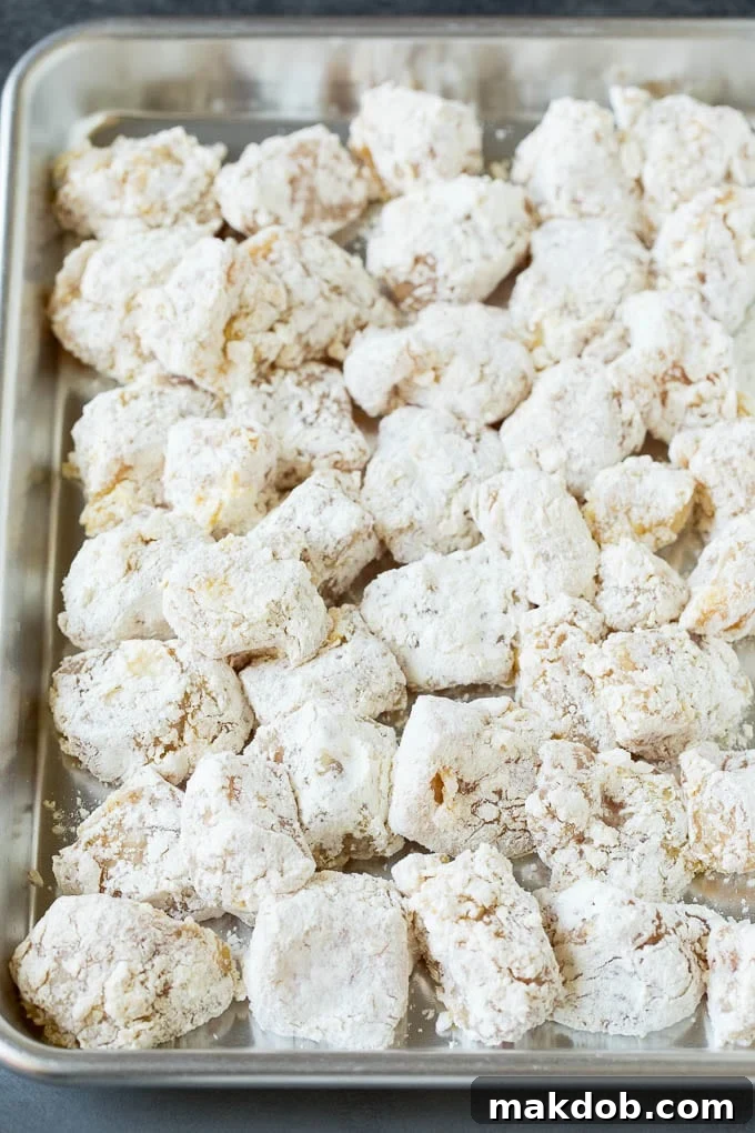 Coated Chicken Pieces for Frying Chicken pieces coated in corn starch and flour, ready for frying.