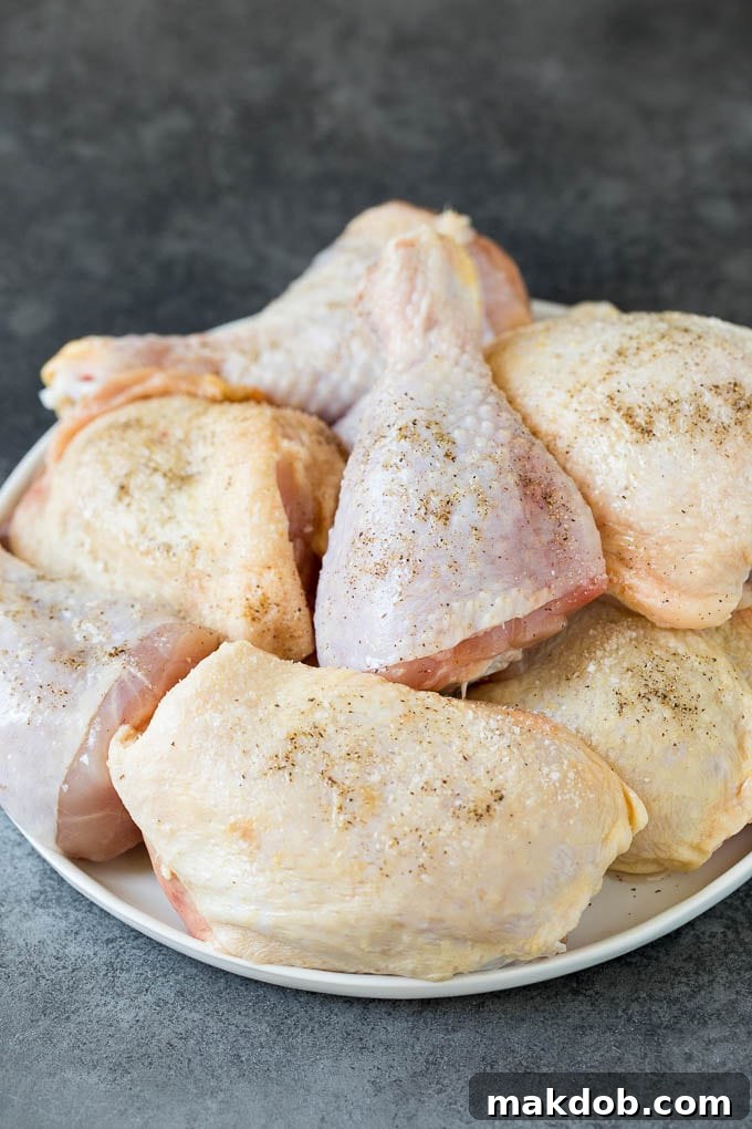 Super easy BBQ chicken that can be grilled or baked with perfect results every time! Raw chicken pieces on a plate.