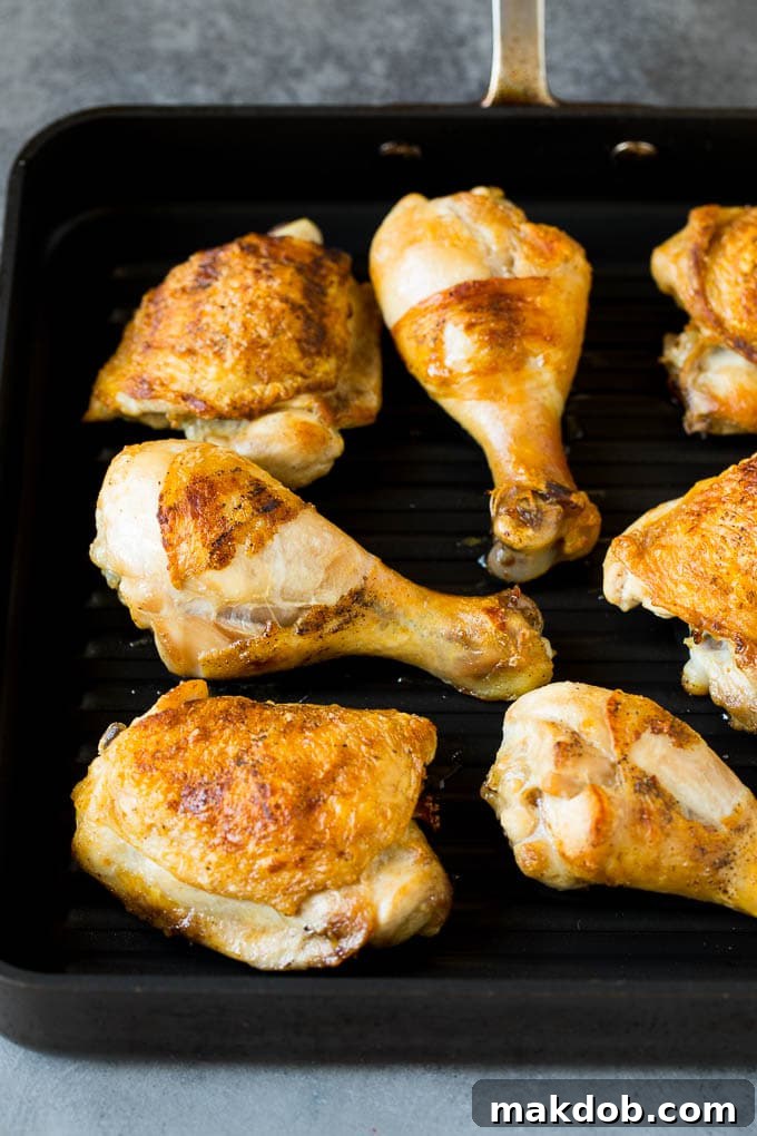 Super easy BBQ chicken that can be grilled or baked with perfect results every time! Chicken thighs and drumsticks on a grill pan.