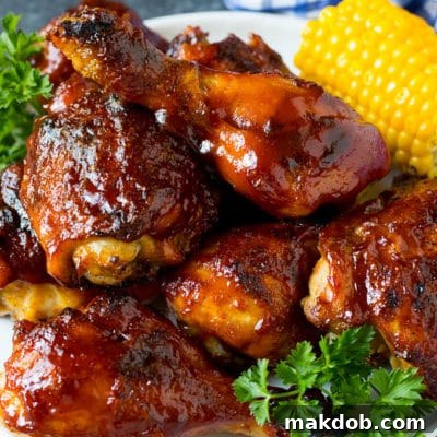 Perfect BBQ Chicken 2 A platter of BBQ chicken garnished with corn on the cob and parsley.