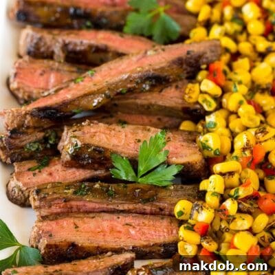 Sliced grilled flank steak on a platter.
