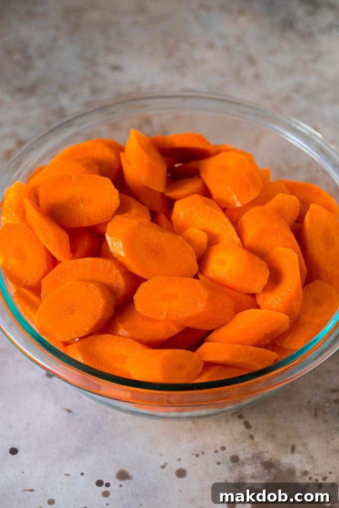 Sliced carrots in a glass bowl.