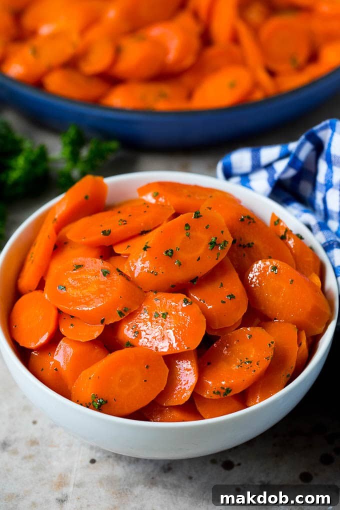 A serving bowl of honey glazed carrots.
