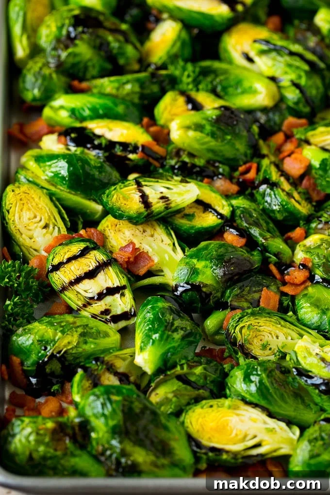 Balsamic brussels sprouts with crispy bacon and fresh parsley served on a rustic pan.