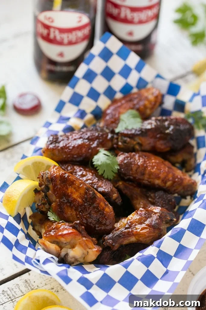 Delicious baked chicken wings smothered in sweet and tangy Dr. Pepper BBQ sauce, ready for game day