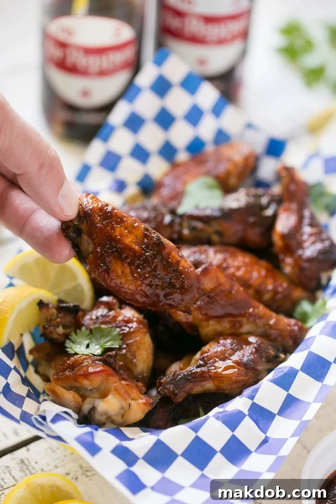 Crispy oven-baked chicken wings coated in homemade barbecue sauce, perfect for a gathering