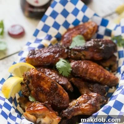 Sweet and tangy baked chicken wings, extra crispy without frying, covered in homemade barbecue sauce.
