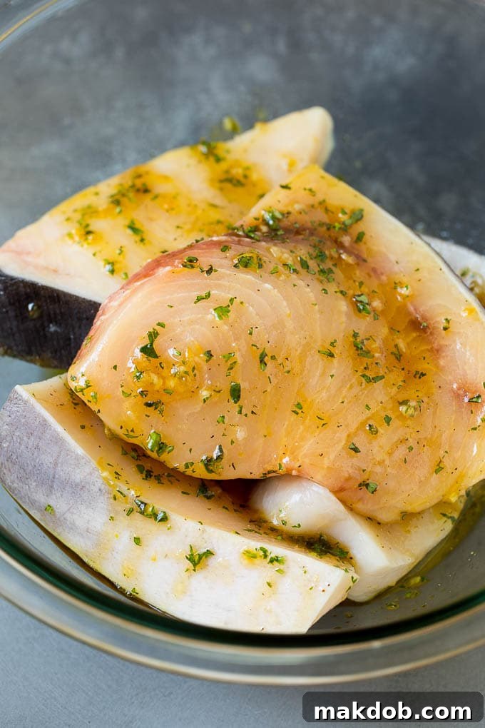 Swordfish steaks in a garlic and herb marinade, ready for the grill.