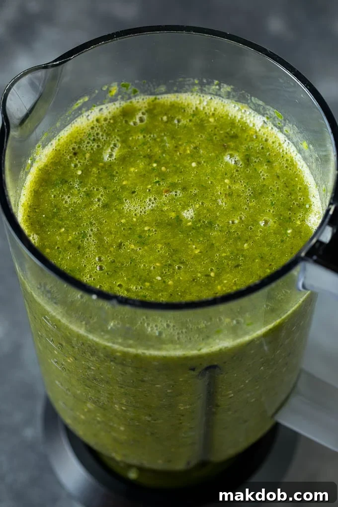 A puree of tomatillos, chiles and cilantro in a blender.