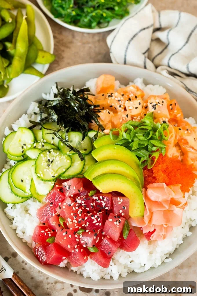 This sushi bowl recipe is assorted fresh fish, avocado, cucumber and seaweed, all served over rice with spicy mayo, picked ginger and tobiko. A sushi bowl topped with salmon, ahi, avocado, cucumber and nori.