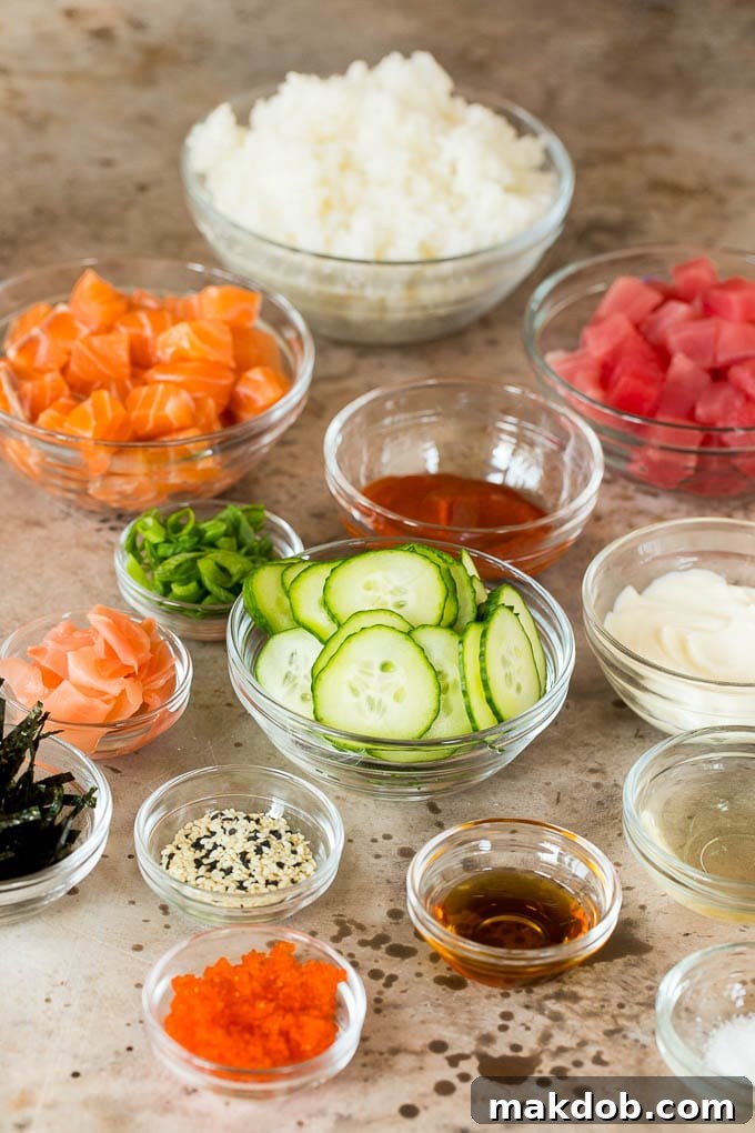 This sushi bowl recipe is assorted fresh fish, avocado, cucumber and seaweed, all served over rice with spicy mayo, picked ginger and tobiko. Bowls of diced fish, cucumbers, rice and seasonings.