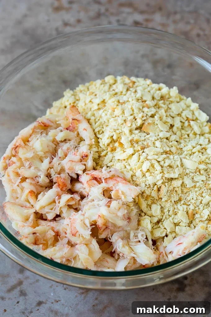 These Maryland crab cakes are fresh crab combined with seasonings and cracker crumbs, then baked to make an easy yet elegant appetizer or main course. Crab meat and cracker crumbs in a bowl.