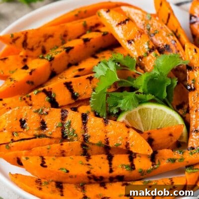 A plate of grilled sweet potatoes topped with cilantro lime dressing.