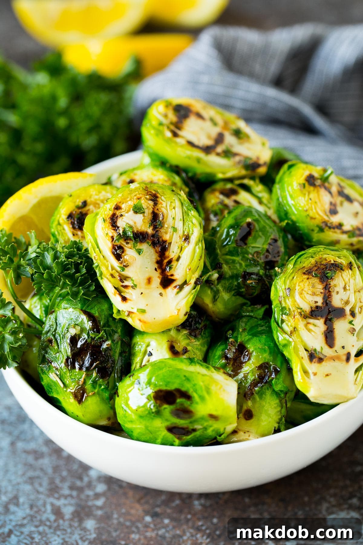 Flame-Kissed Brussels Sprouts 6 A bowl of grilled brussels sprouts topped with parsley.