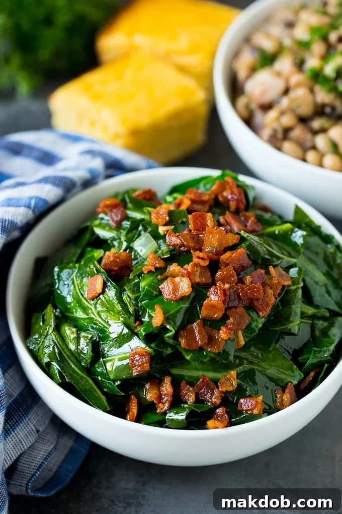 These Southern style collard greens are simmered with bacon and seasonings until tender and flavorful. A bowl of tender, flavorful collard greens next to a bowl of black eyed peas and cornbread, representing a classic Southern meal.