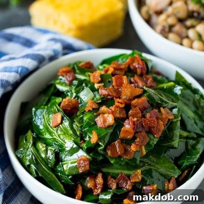 A bowl of collard greens next to a bowl of black eyed peas and cornbread.