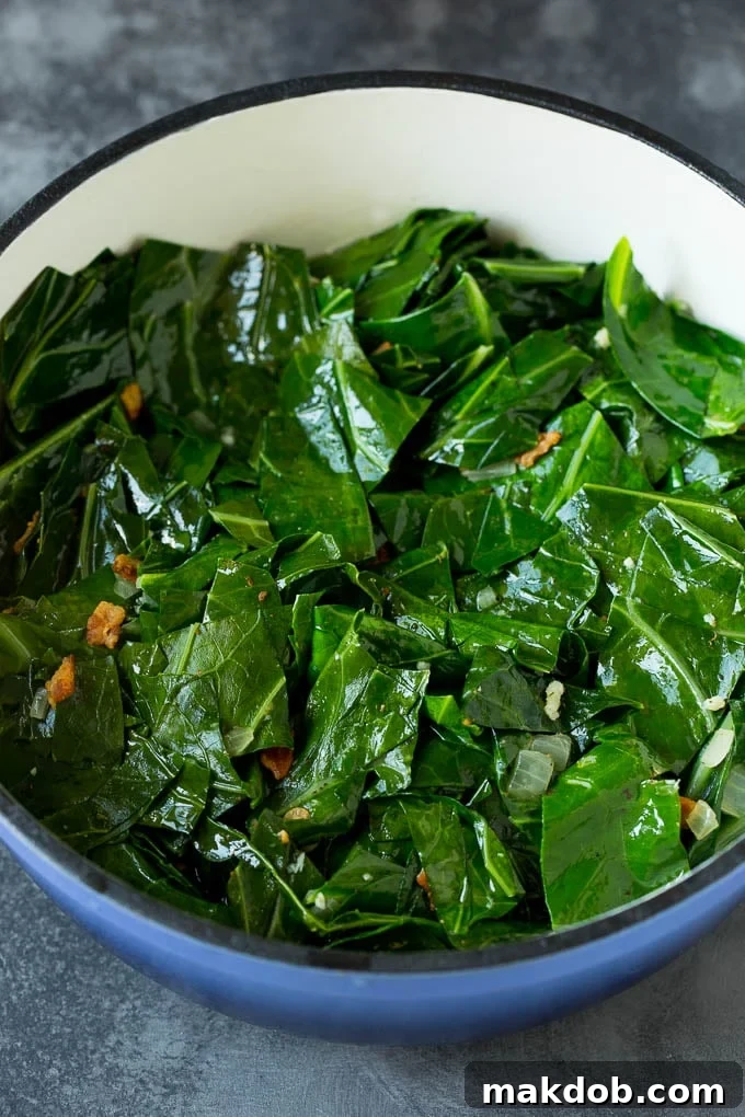 These Southern style collard greens are simmered with bacon and seasonings until tender and flavorful. Perfectly cooked collard leaves, tender and glistening, topped with crispy bacon bits, ready to be served as a delightful side.